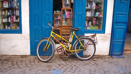 Yellow bicycle in front of a shop in Essaouira, Morocco