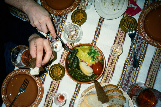 Family sharing classic russian food and celebrating with vodka