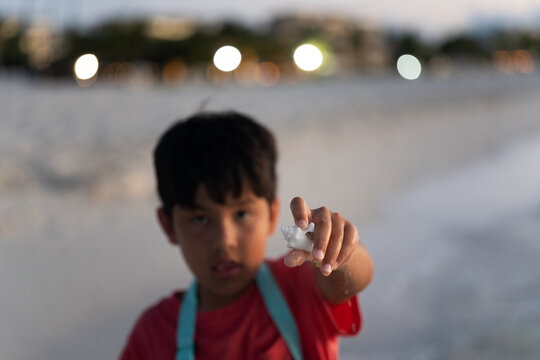 Holding up a sea shell