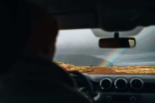car driving at rainy weather - sunny rainbow 