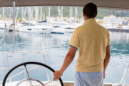 Man at the steering wheel waits for berthing 