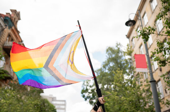 Anonymous Person Holding New Progress Pride Flag Outdoors
