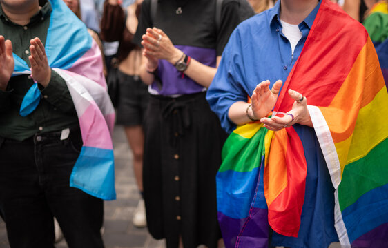 Anonymous People Covered With Pride Flags On The Street 