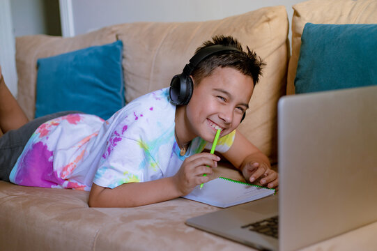 boy with laptop with headphones