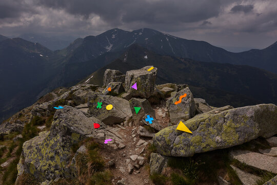 Conceptual Still life with multicolored figures in the mountains