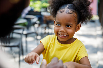 Playful Little girl smiling at dad