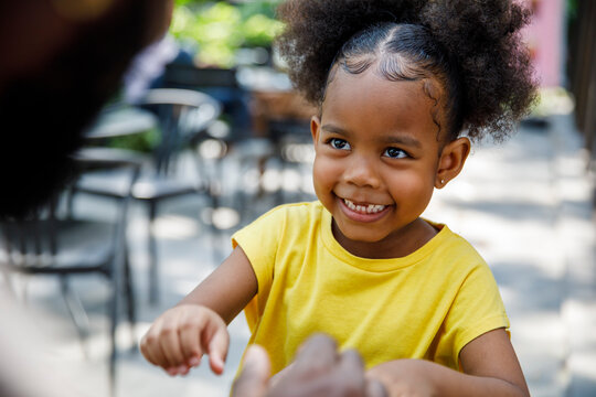 Playful Little girl smiling at dad