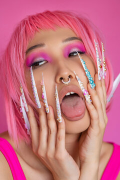 Asian woman with pink hair and trendy nails