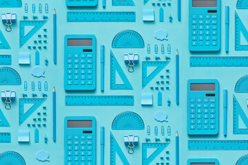 Pattern of various blue-colored office supplies.