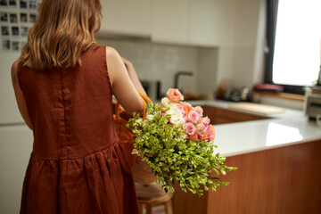 Woman carrying a bag of flowers