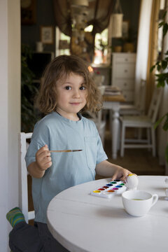 Adorable boy painting  at home 