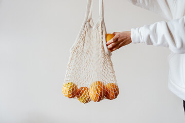 Woman With Eco Friendly Shopping Bag And Oranges