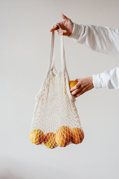 Woman With Eco Friendly Shopping Bag And Oranges