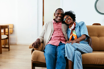 Cheerful couple portrait in a bright home