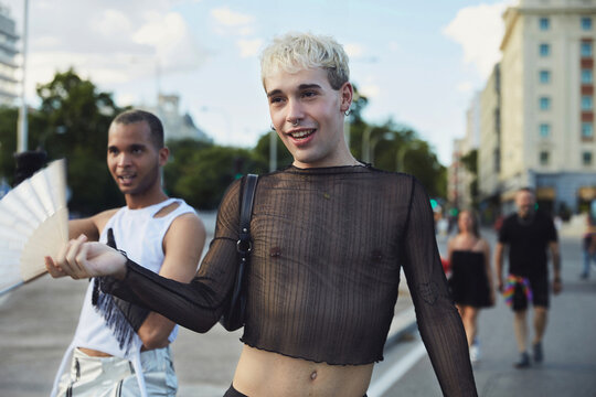 Two queer friends striking poses and voguing on the street