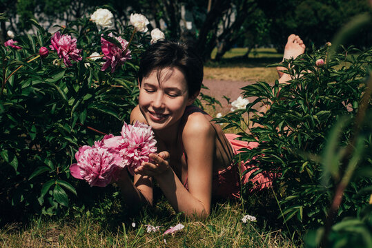 Woman among peonies