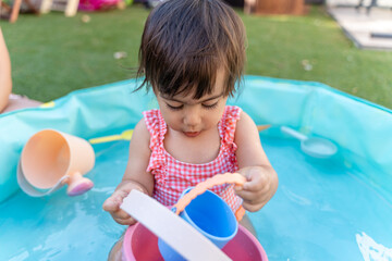 little girl playing in the swimming pool