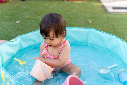 little girl playing in the swimming pool