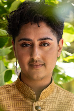 portrait of stylish nonbinary person surrounded by plants