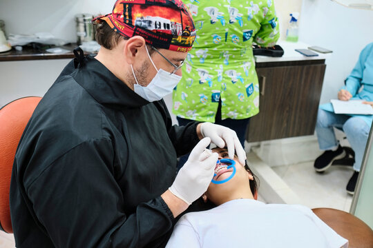 Dentist applying fluoride to a patient's teeth