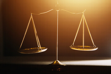 Business and lawyers discussing contract papers with brass scale on desk in office. Law, legal services, advice, justice and law concept picture with film grain effect