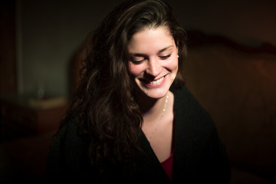 Candid dark portrait of laughing woman