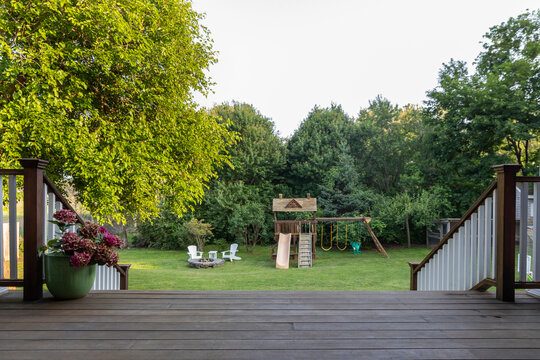 View to backyard of home from Porch with nobody and swing set 