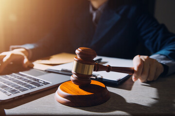 Business and lawyers discussing contract papers with brass scale on desk in office. Law, legal services, advice, justice and law concept picture with film grain effect
