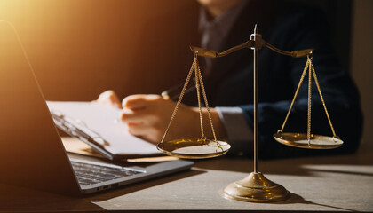 Business and lawyers discussing contract papers with brass scale on desk in office. Law, legal...