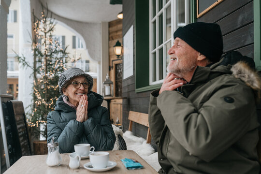 Senior Couple Enjoying Coffee on Snowy Day