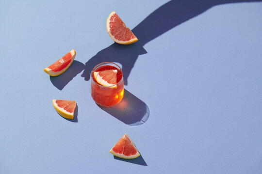 Glass of grapefruit juice and fresh citrus slices