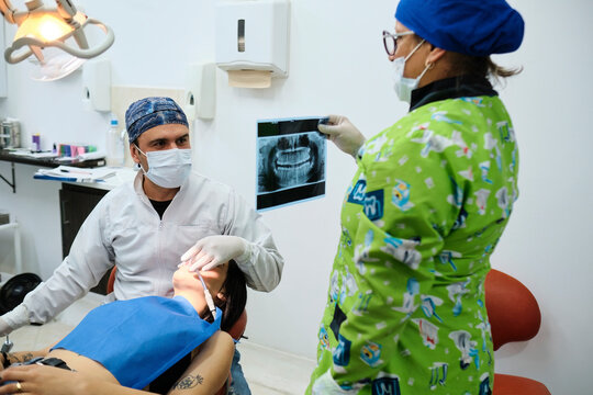 Dentist looking at the patient's x-rays