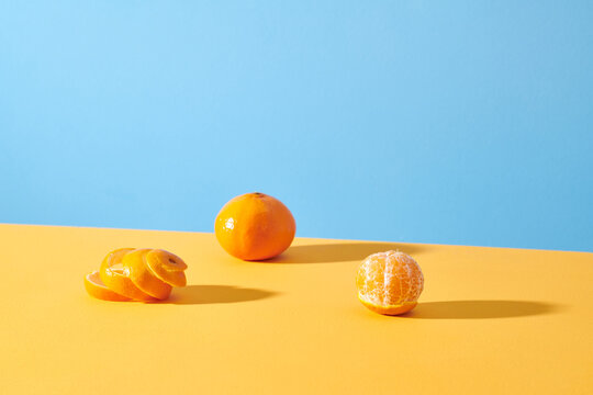 Tangerines on yellow background with copy space