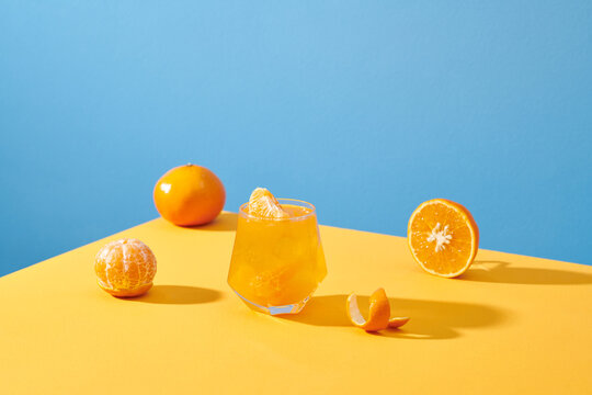 fresh tangerines and a glass of their juice. Healthy food concept.