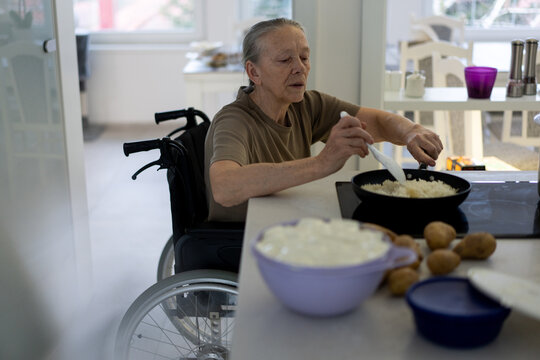 Senior Lady in Wheelchair Cooking