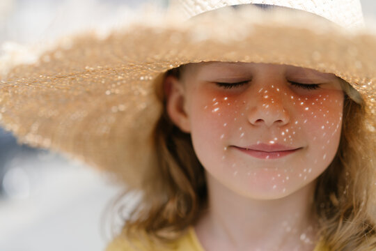 Naklejki Portrait of a girl in a straw hat