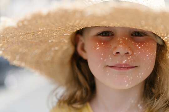Little girl in a hat on sunny day