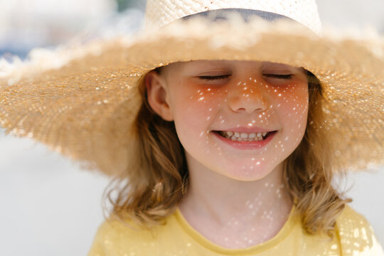 Little girl in a straw hat on sunny day