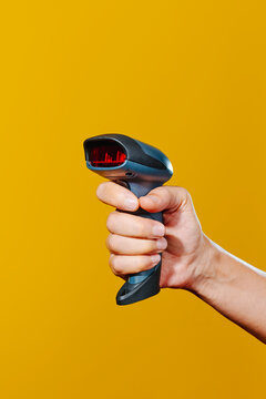 man grasping a barcode scanner