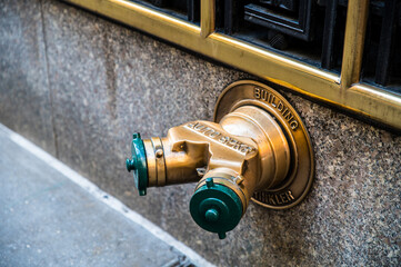 Fire hydrant on wall in city