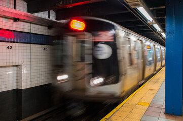 View of subway station with platform and moving train