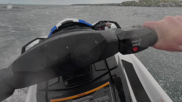 POV shot of a jet skier racing across the choppy waves getting airtime