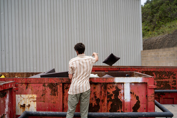 Man dumping furniture at recycling clean point