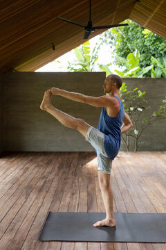 Image of a male yogi stretching during a yoga class