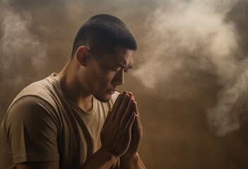 young man praying in the dark