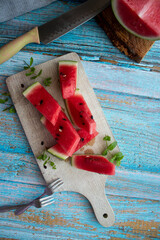 Watermelon slices in a glass on a wooden background. 
Slices of watermelon on a wooden board. 