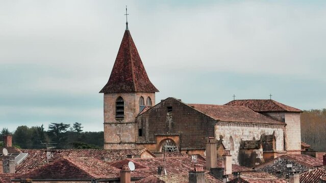 Drone elevation over the church of Monpazier, aerial shot, the little town is a unique bastide in France, bastide in Dordogne