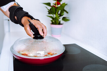 Man with adjustable elbow brace preparing food