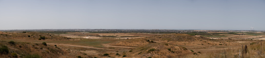 Panoramic view of the Gaza Strip, as seen from Assaf Siboni overlook in southern Israel. High-rises, farmlands, and other features of the Gaza Strip are visible.