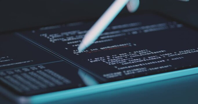 Operator works on tablet screen on program code with stylus. Concept of digital work, programming of applications